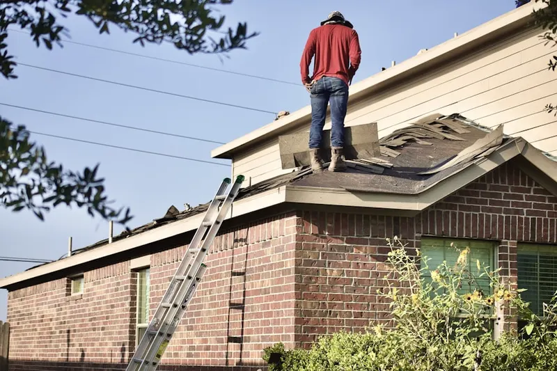 Professional roofer working on a residential roof in Gardenville
